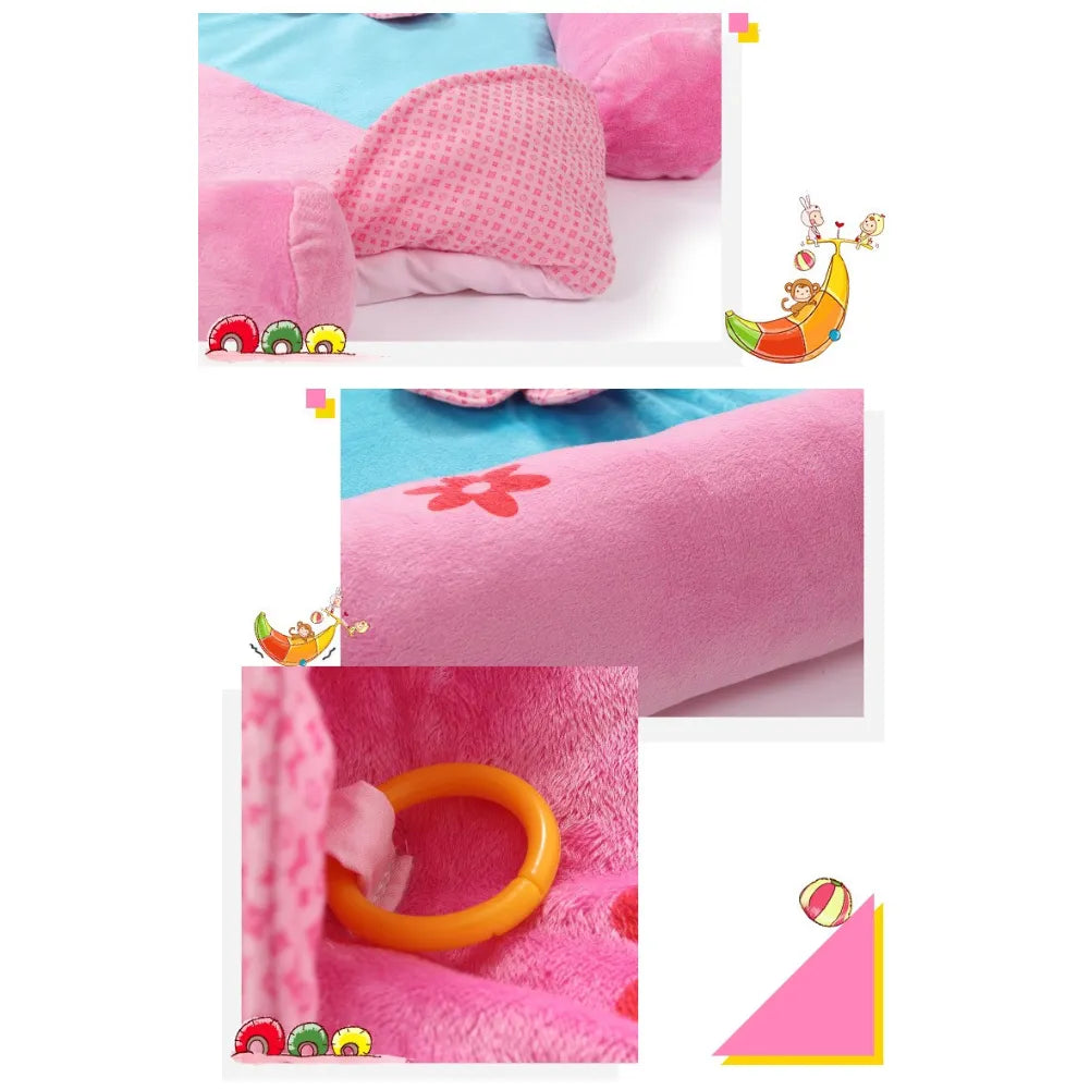 Close-up of floral baby play mat featuring soft pink fabric and colorful toy ring for sensory stimulation.